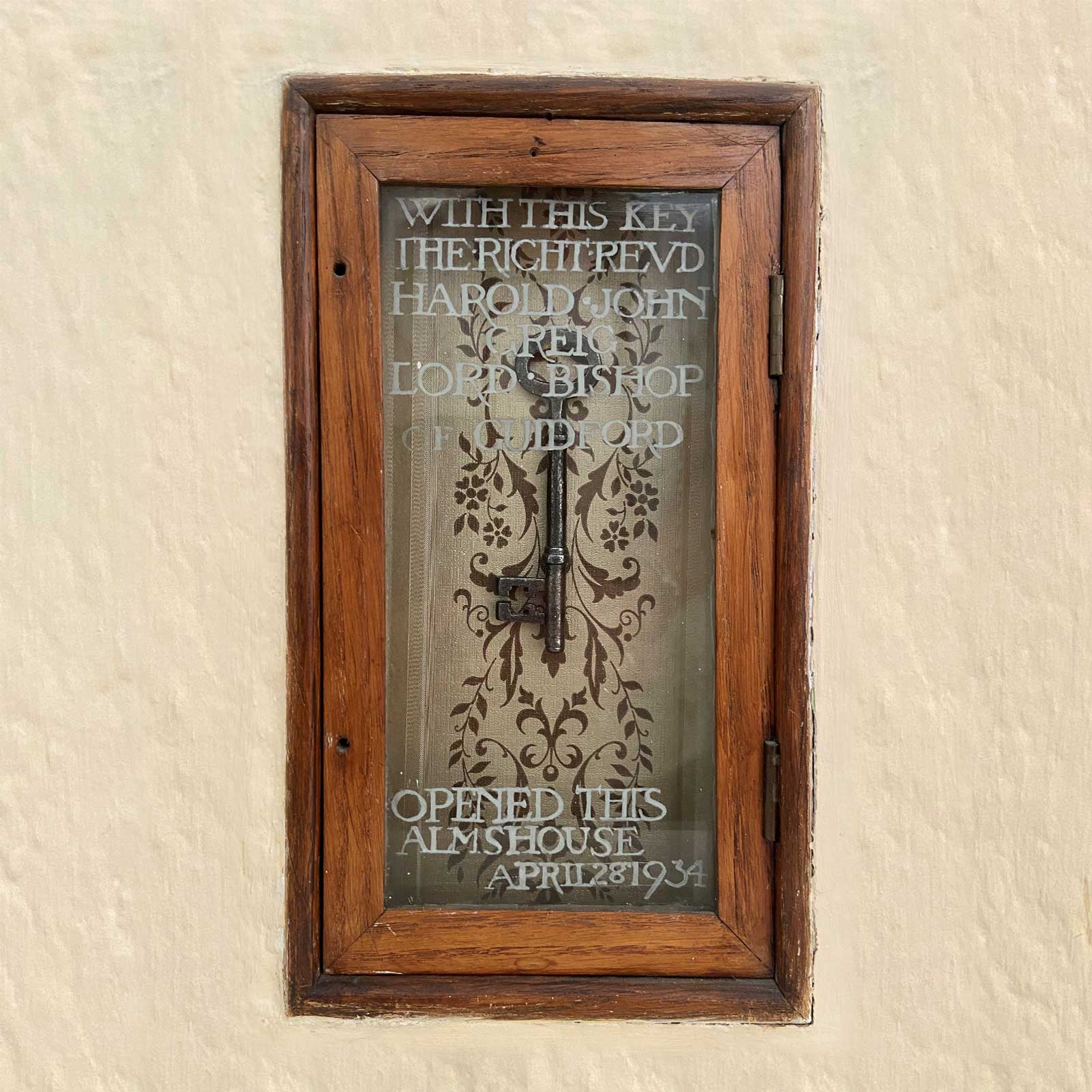 Old key in presentation glass wood framed glass case with etched writing